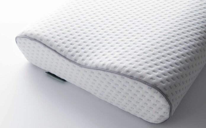 A memory foam pillow on a bed. How to Dry a Memory Foam Pillow.