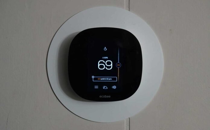 An eccobee thermostat showing the room temperature to be 69 degrees which is just about the best temperature for sleep.