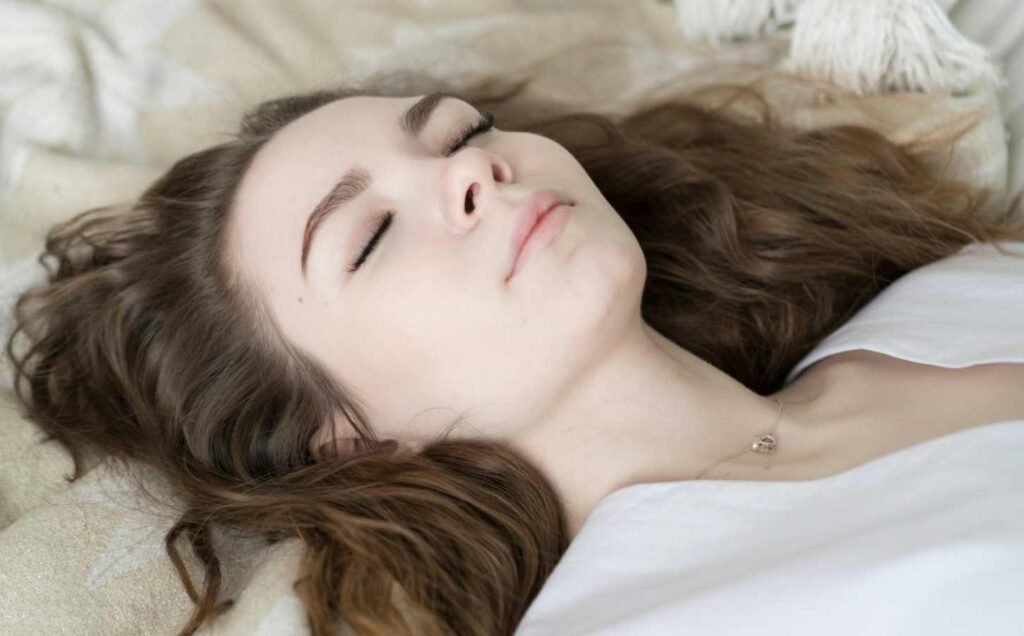 Close up, head and shoulders of a female sleeping after applying the 10-3-2-1-0 sleep rule.