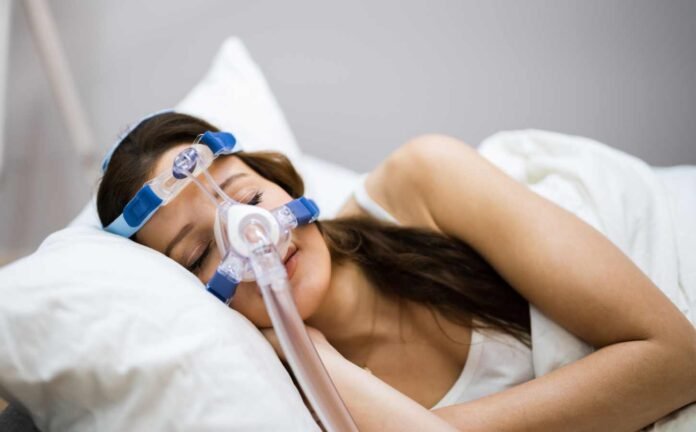 A woman sleeping with a Continuous Positive Airway Pressure mask on.