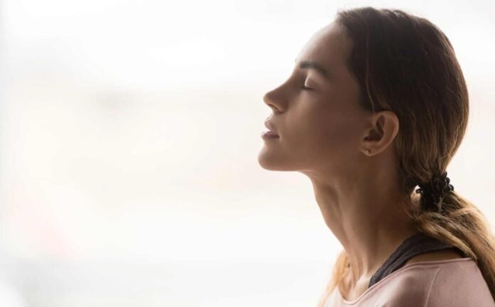 A young woman practicing here myofunctional therapy.